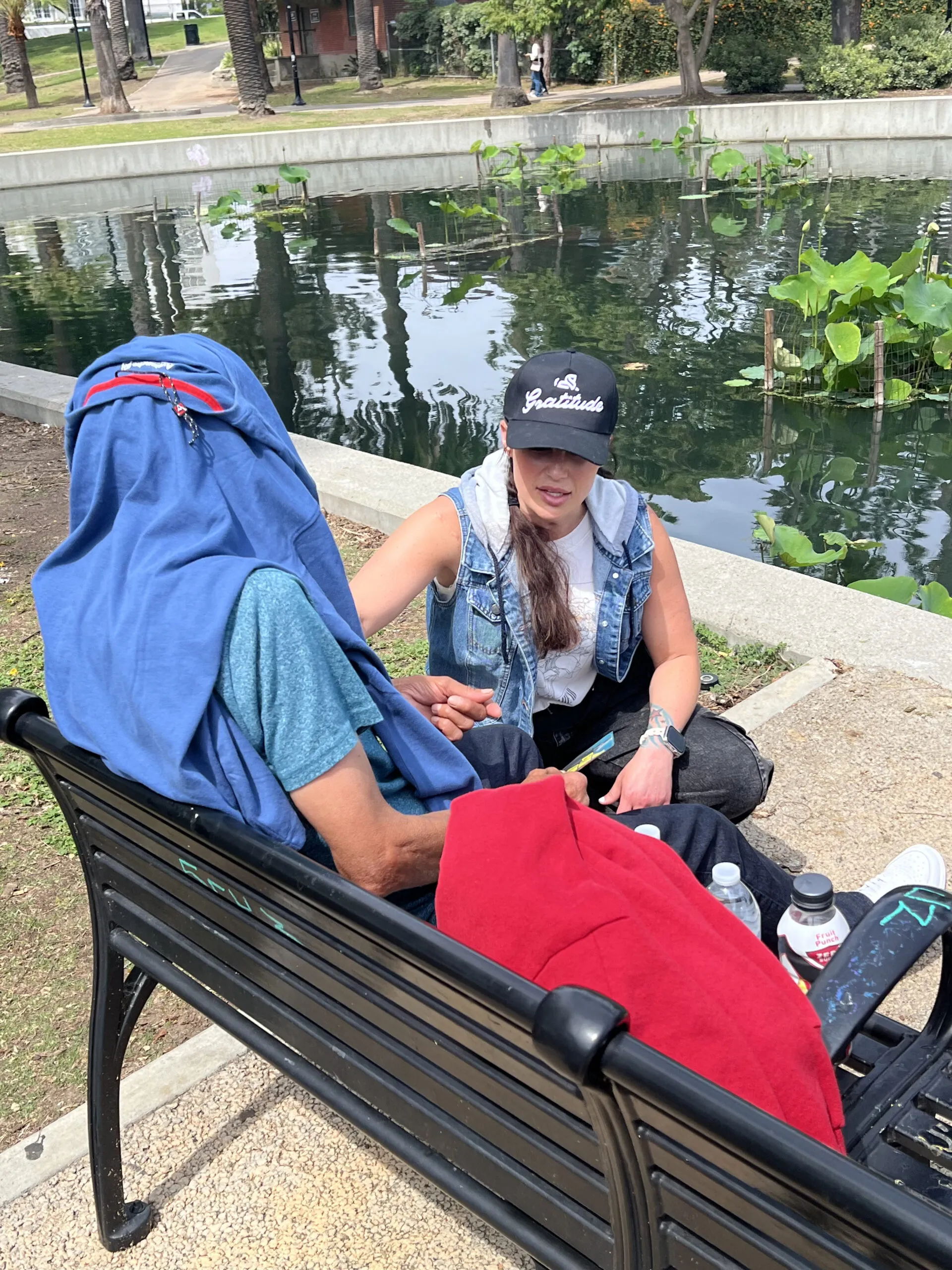 Bridgette speaking with someone on a park bench